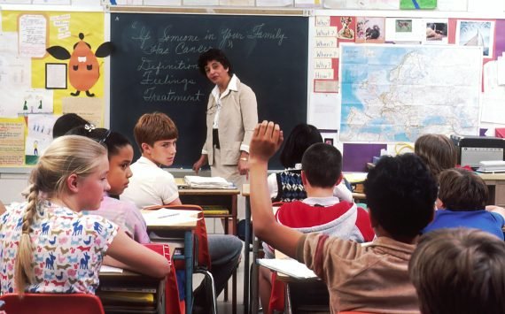 Teacher standing in front of a group of children