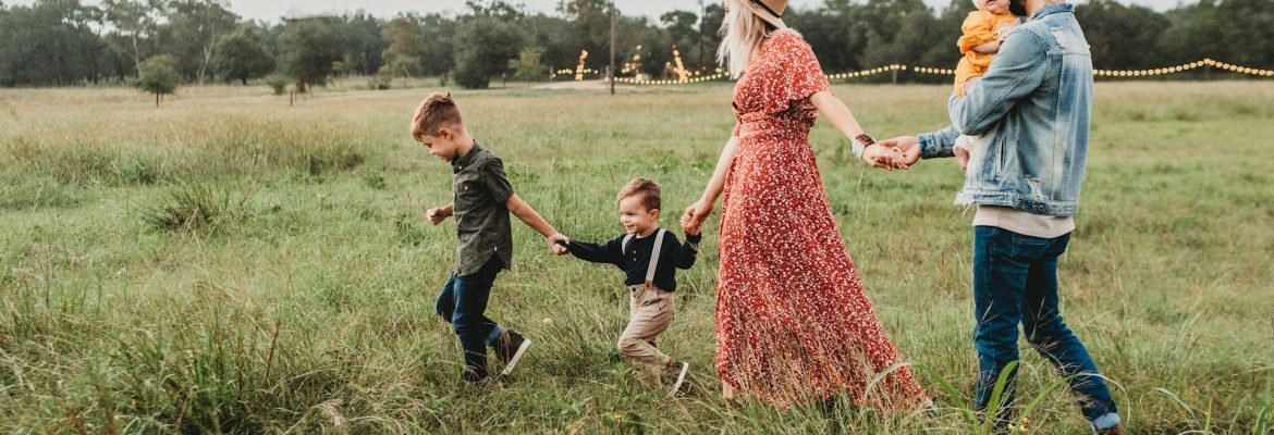 Family holding hands with a toddler