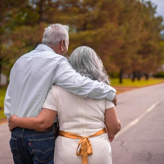 Older couple walking arm in arm