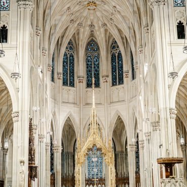 People sitting in pews inside a cathedral