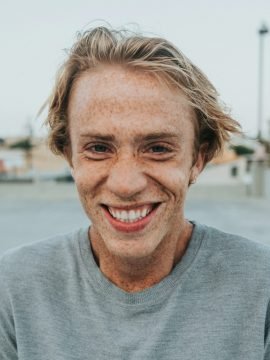 Portrait of a smiling man in a gray shirt