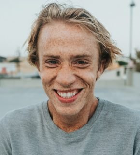 Portrait of a smiling man in a gray shirt