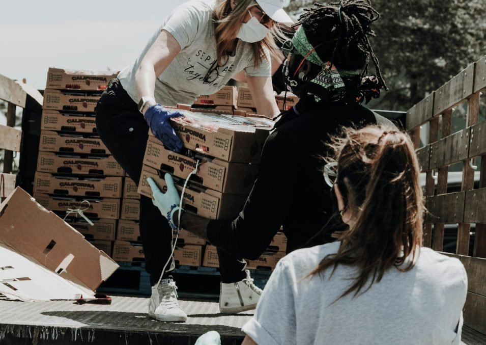 Volunteers loading boxes of food onto a truck