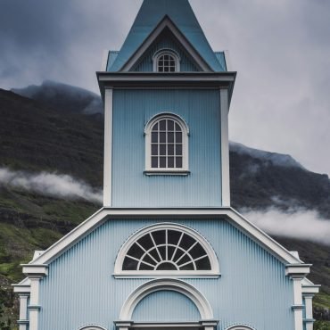 Blue and white wooden church on a sunny day